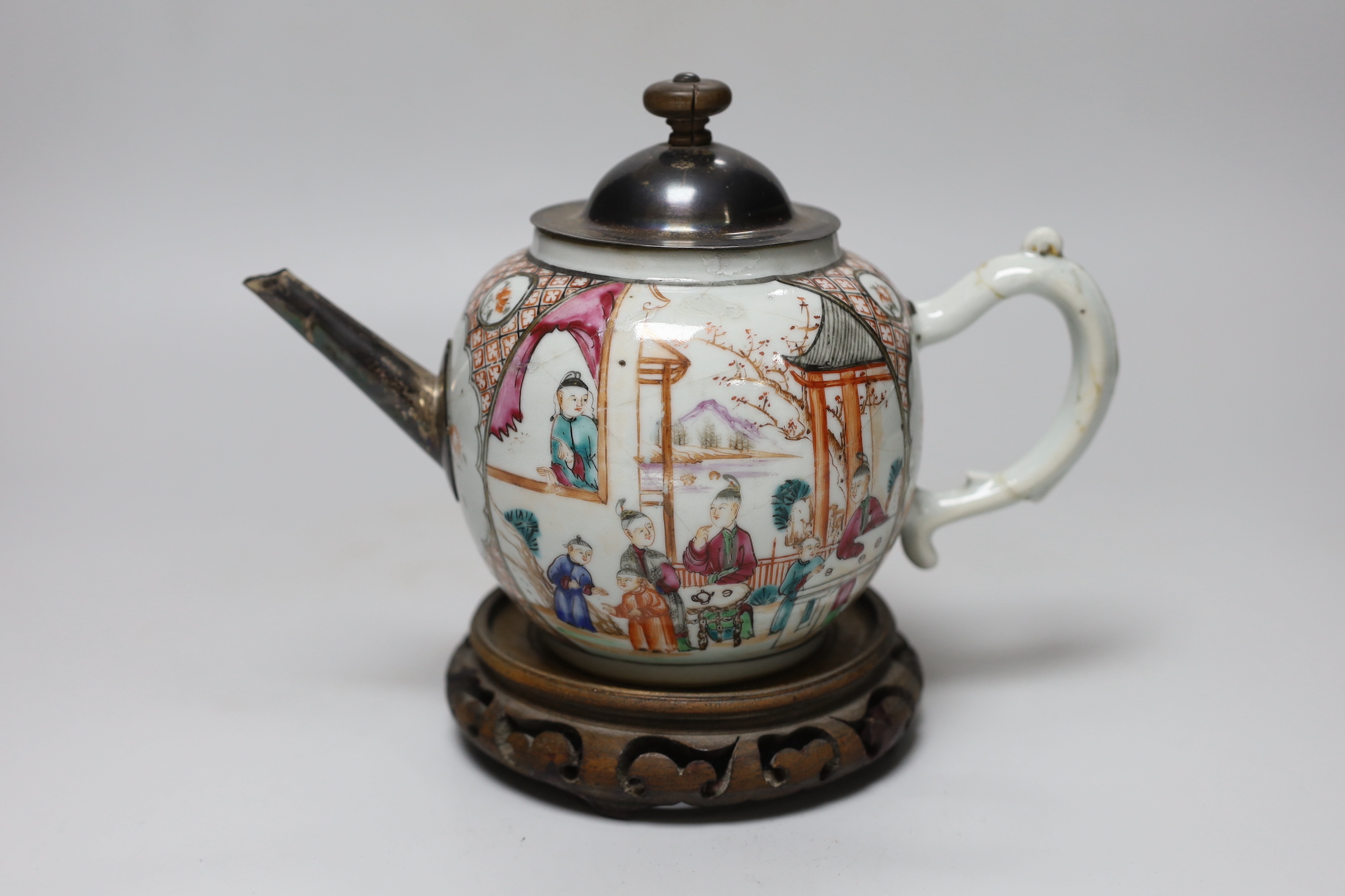 An 18th century Chinese export famille rose teapot with later silver spout and cover, on hardwood stand